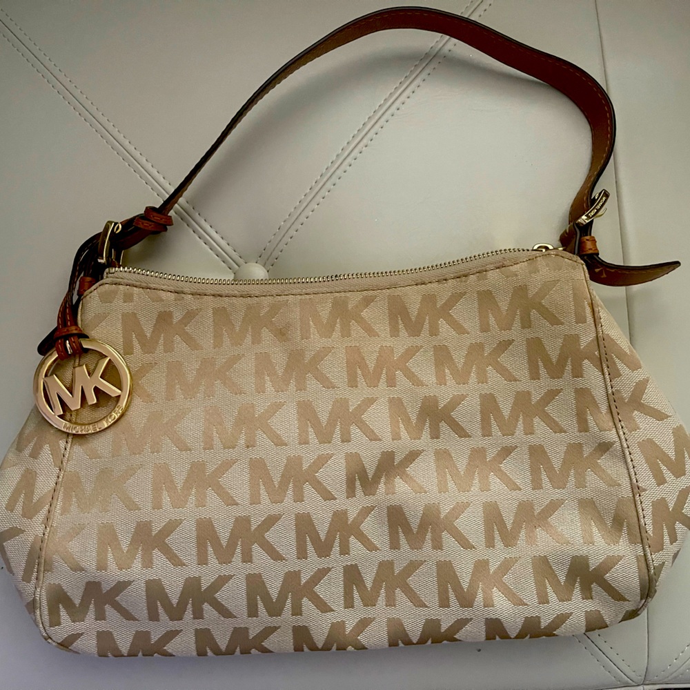 Michael Kors Purse with Leather strap and gold tone accents.